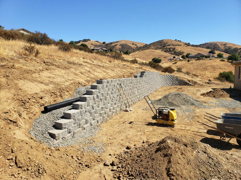 Retaining Walls in Summer: Build the Wall Now, Beat the Rain Later